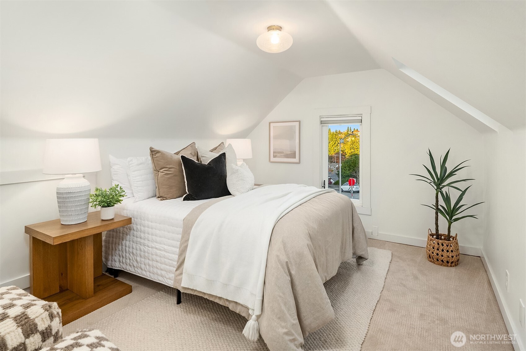 2503 37th Avenue West Seattle, WA 98199 - Photo 24 of 36 a bedroom with bed and a potted plant