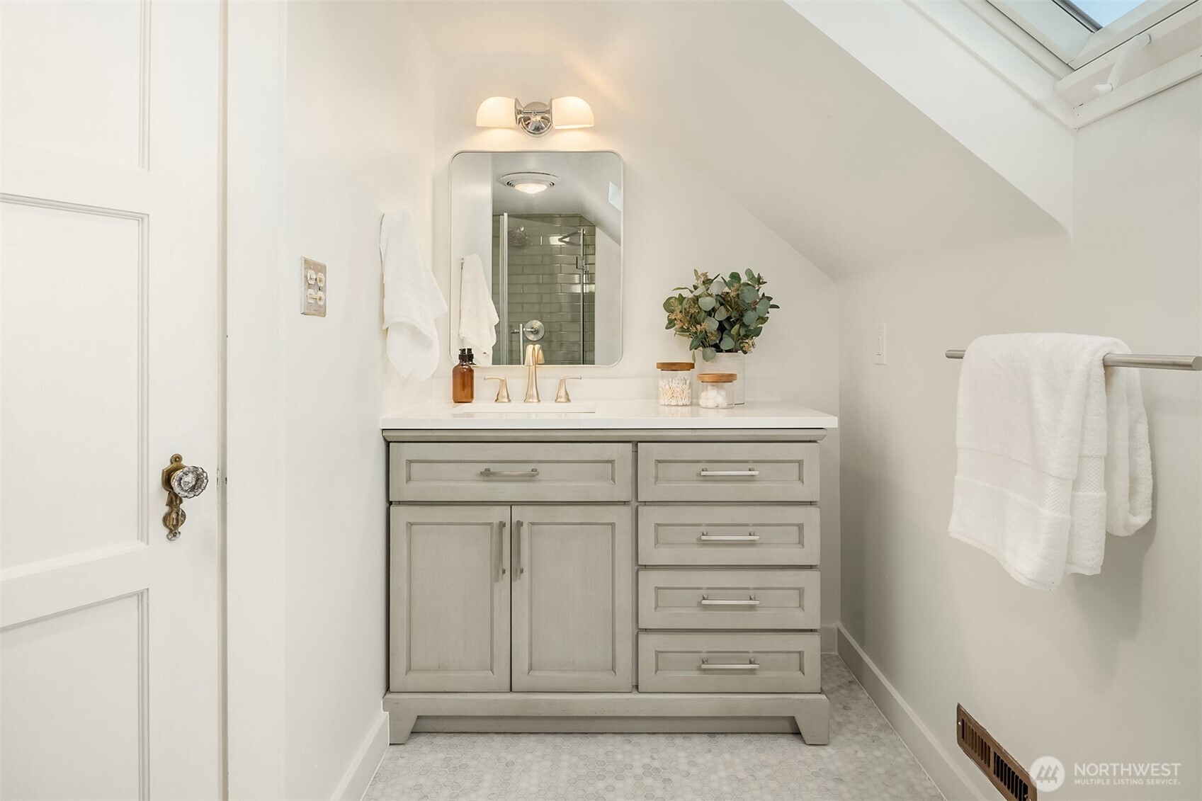 2503 37th Avenue West Seattle, WA 98199 - Photo 25 of 36 a bathroom with a sink vanity and mirror