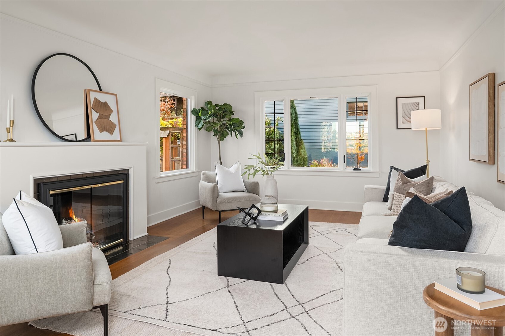 2503 37th Avenue West Seattle, WA 98199 - Photo 5 of 36 a living room with furniture a fireplace and a large window