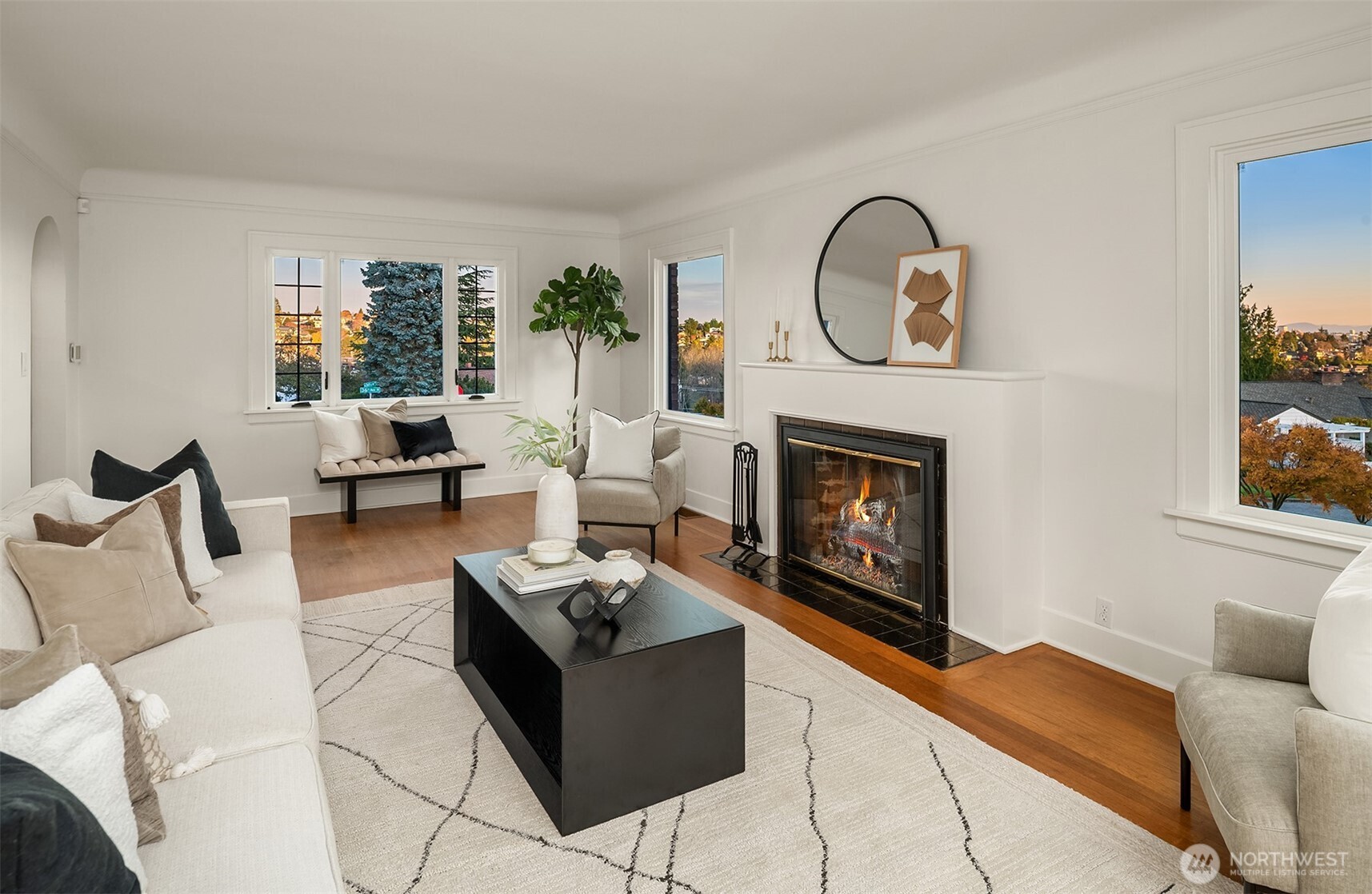 2503 37th Avenue West Seattle, WA 98199 - Photo 6 of 36 a living room with furniture a rug and a fireplace