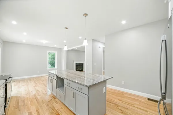 a large white kitchen with a sink and dishwasher