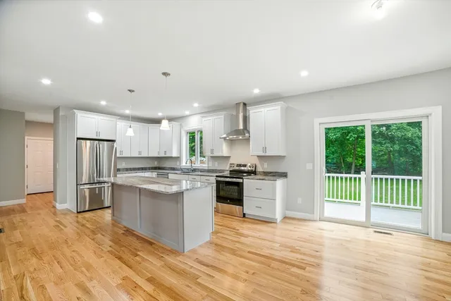 a kitchen with stainless steel appliances granite countertop a stove and a sink