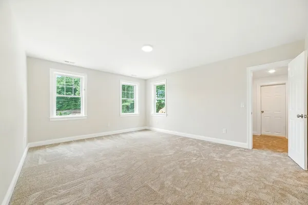 an empty room with windows and closet