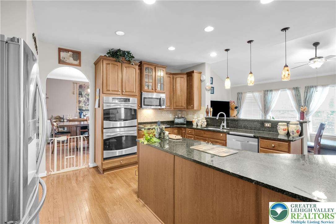 222 Lower Way Road Easton, PA 18045 - Photo 15 of 45 a kitchen with stainless steel appliances granite countertop a stove a sink and a refrigerator