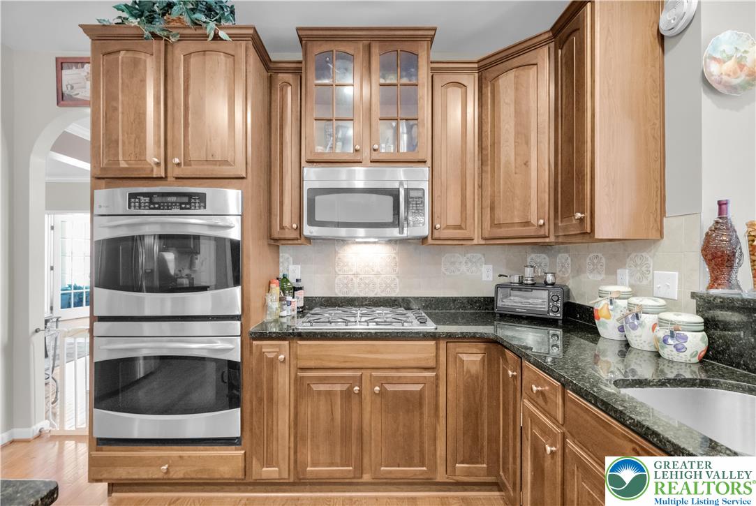 222 Lower Way Road Easton, PA 18045 - Photo 16 of 45 a kitchen with granite countertop a stove a sink and dishwasher a refrigerator with wooden cabinets