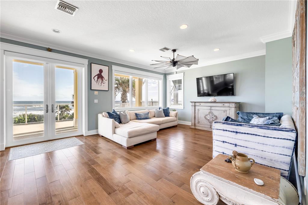 6101 Turtlemound Road New Smyrna Beach, FL 32169 - Photo 19 of 82 a living room with furniture and a flat screen tv