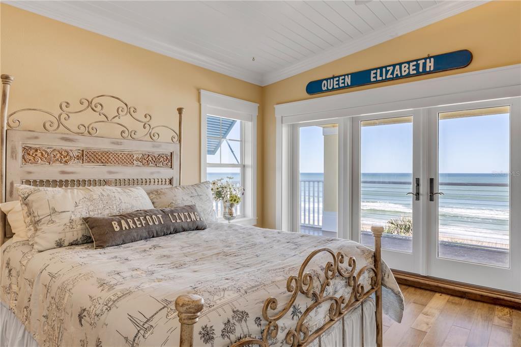 6101 Turtlemound Road New Smyrna Beach, FL 32169 - Photo 25 of 82 a bedroom with a large bed and a large window with outer view