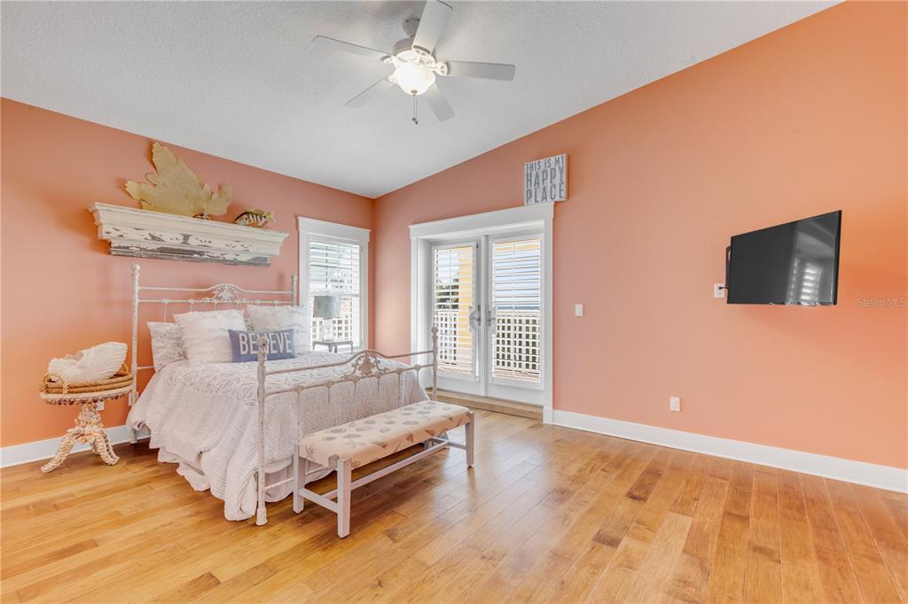 6101 Turtlemound Road New Smyrna Beach, FL 32169 - Photo 43 of 82 a spacious bedroom with a bed and a flat screen tv