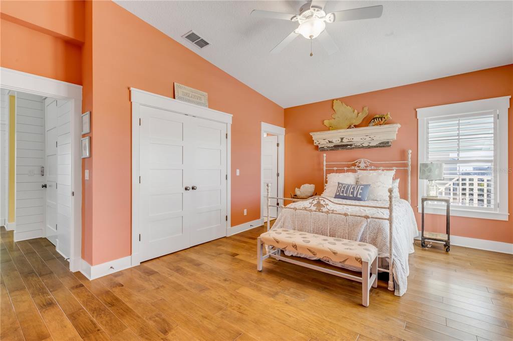 6101 Turtlemound Road New Smyrna Beach, FL 32169 - Photo 44 of 82 a bedroom with a bed and a chandelier