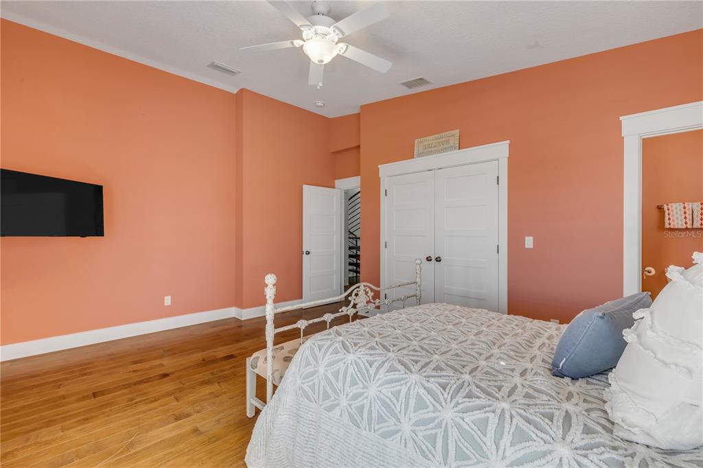 6101 Turtlemound Road New Smyrna Beach, FL 32169 - Photo 45 of 82 a bedroom with a bed and a chandelier