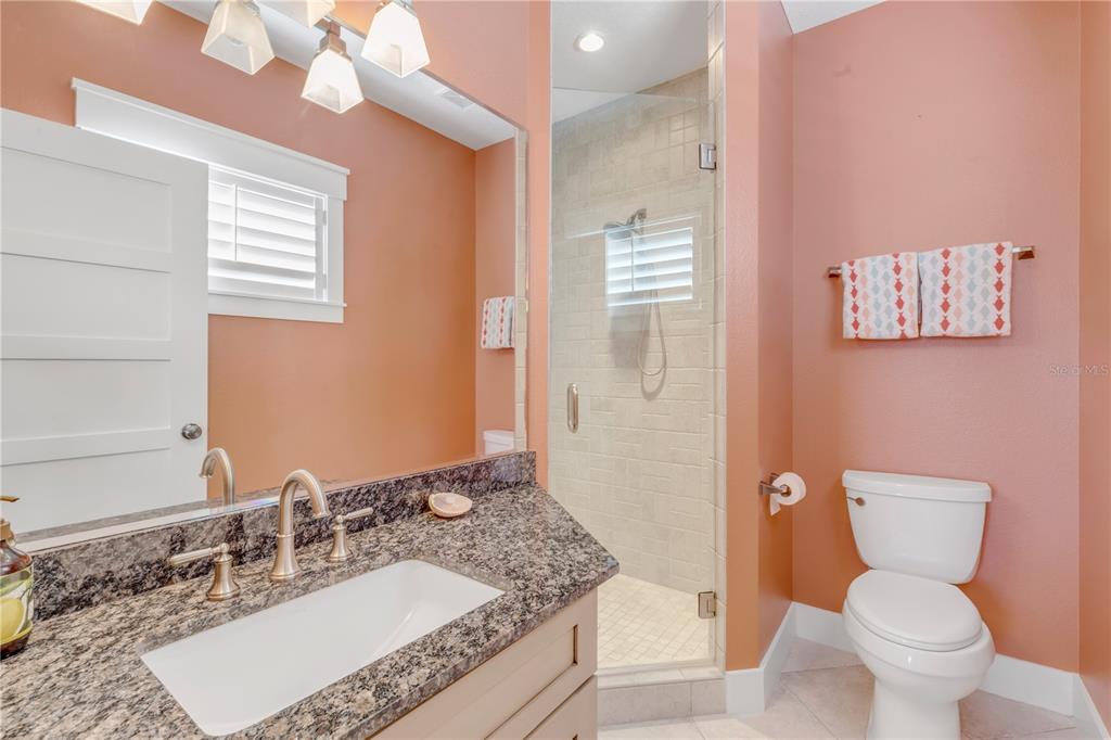 6101 Turtlemound Road New Smyrna Beach, FL 32169 - Photo 47 of 82 a bathroom with a granite countertop sink mirror vanity and toilet