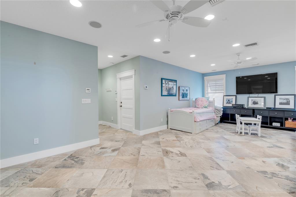 6101 Turtlemound Road New Smyrna Beach, FL 32169 - Photo 61 of 82 a living room with furniture and a flat screen tv