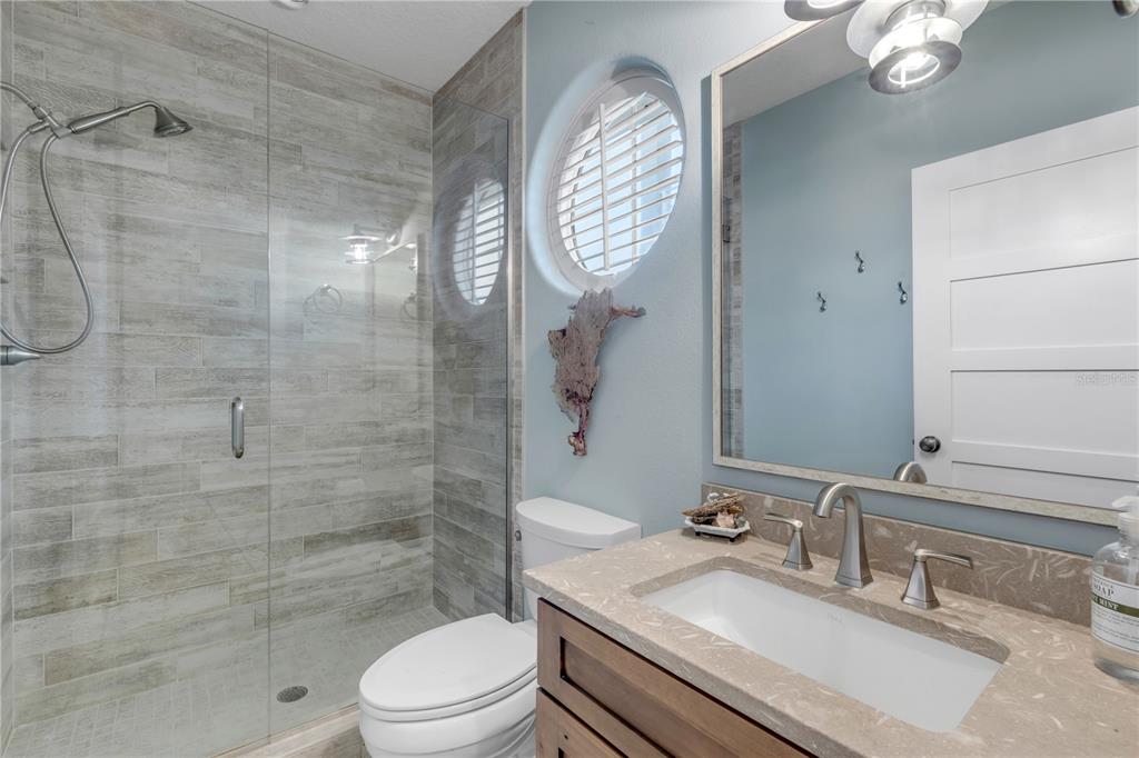 6101 Turtlemound Road New Smyrna Beach, FL 32169 - Photo 62 of 82 a bathroom with a sink a toilet and shower