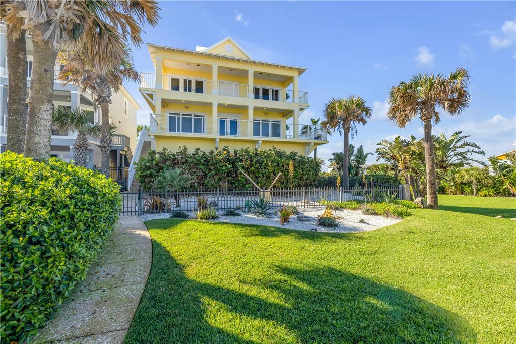6101 Turtlemound Road New Smyrna Beach, FL 32169 - Photo 72 of 82 a view of a house with swimming pool and a yard