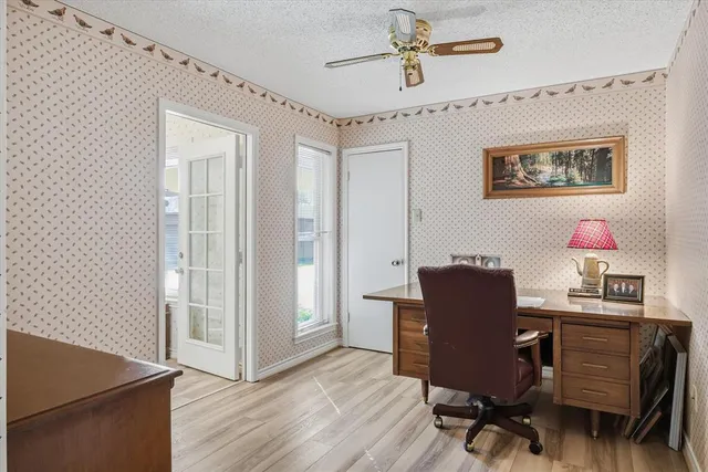 a view of a workspace with furniture and wooden floor