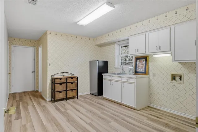 a kitchen with stainless steel appliances a refrigerator sink and stove top oven