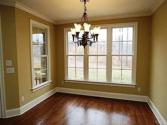 7315 Ridgeline Drive Raleigh, NC 27613 - Photo 4 of 8 a view of a room with wooden floor chandelier and windows