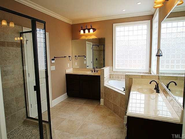 7315 Ridgeline Drive Raleigh, NC 27613 - Photo 6 of 8 a bathroom with a tub sink and mirror