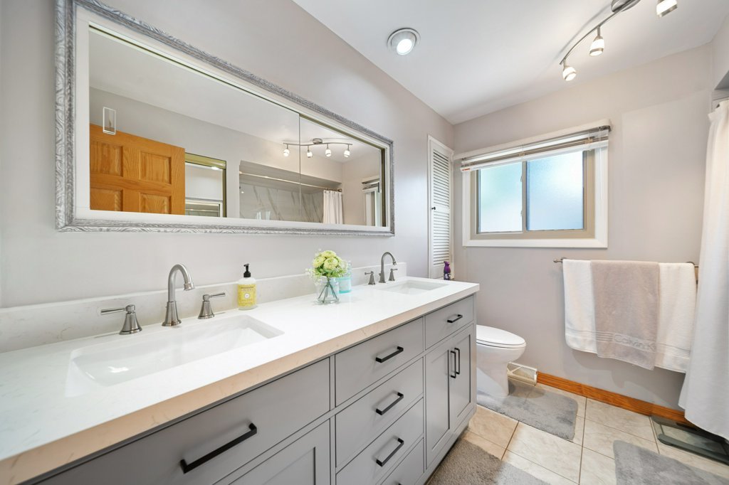 365 West Myrick Avenue Addison, IL 60101 - Photo 19 of 49 a bathroom with a granite countertop sink mirror and bathtub