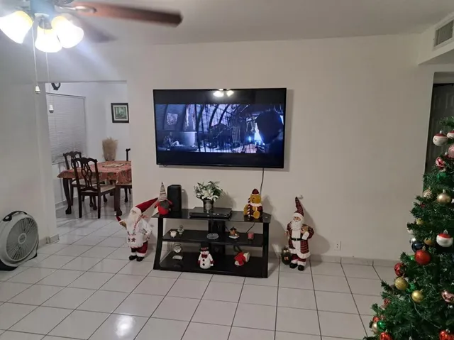 a view of a room with furniture and potted plants