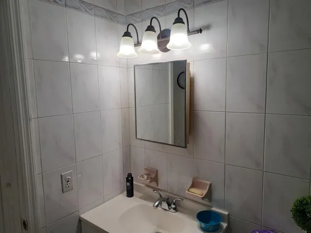 a bathroom with a sink and mirror
