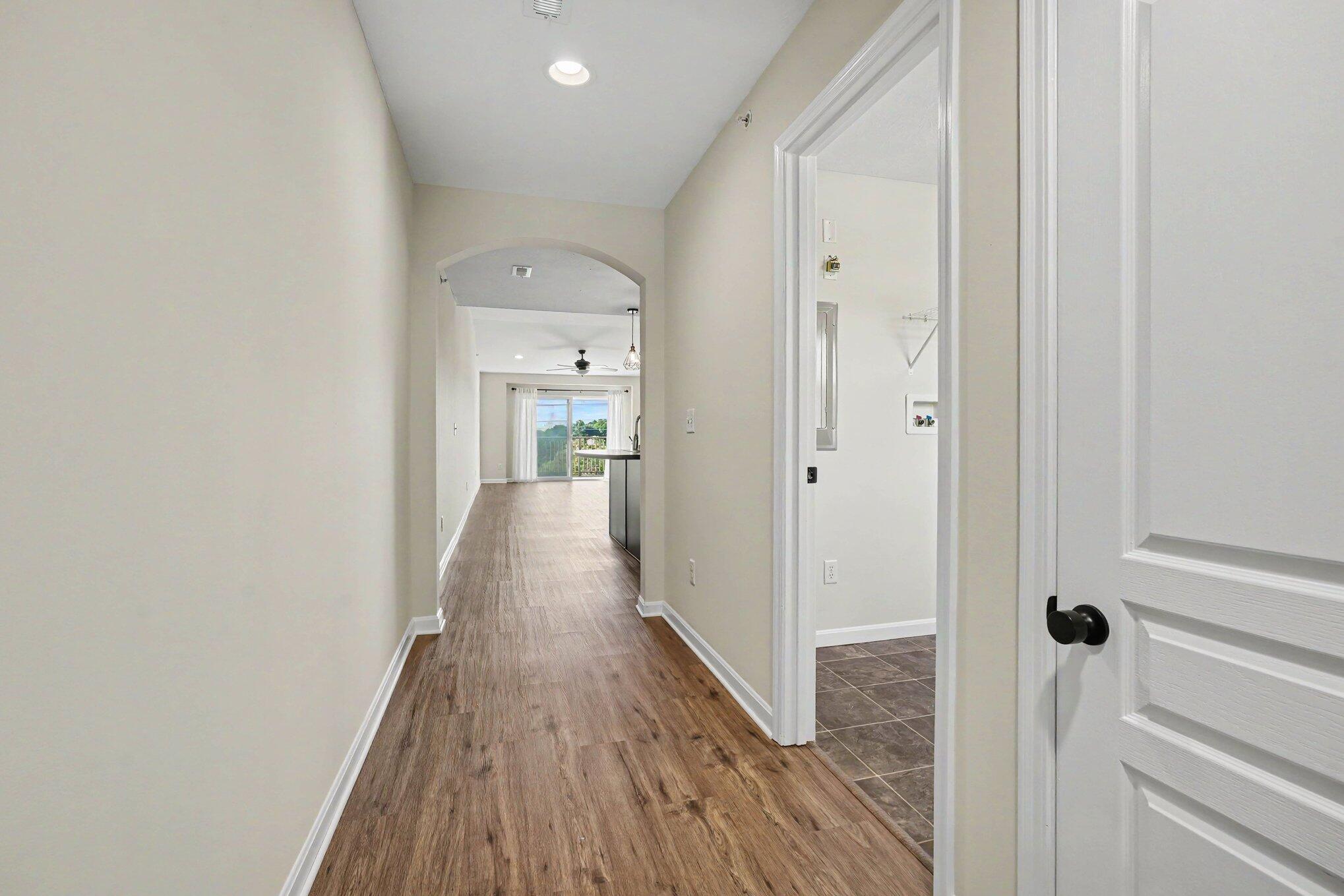6069 Boulder View Cold Spring, KY 41076 - Photo 4 of 23 Hallway featuring an arched entryway, recessed lighting, and a white paneled door with black hardware