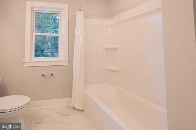 a bathroom with a bathtub and window