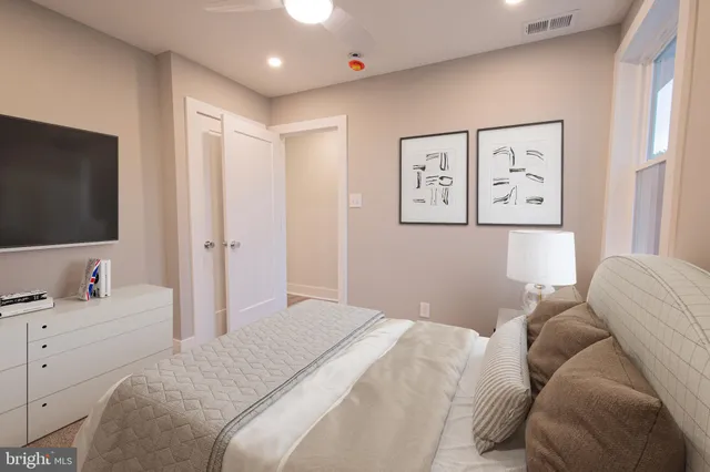 a bedroom with a large bed and a flat screen tv