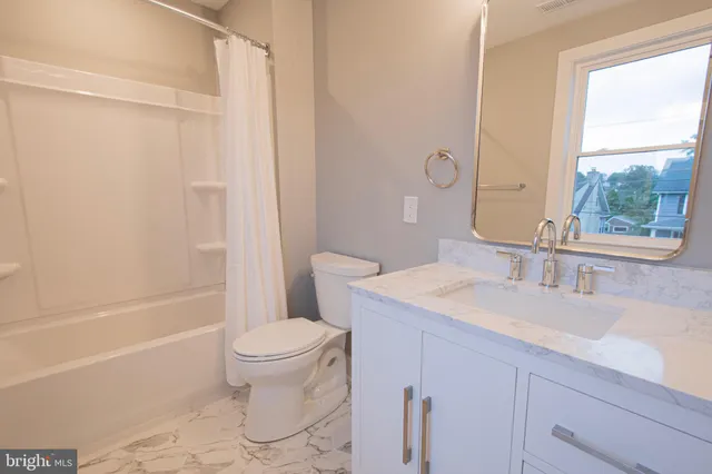 a bathroom with a sink a toilet and a bathtub