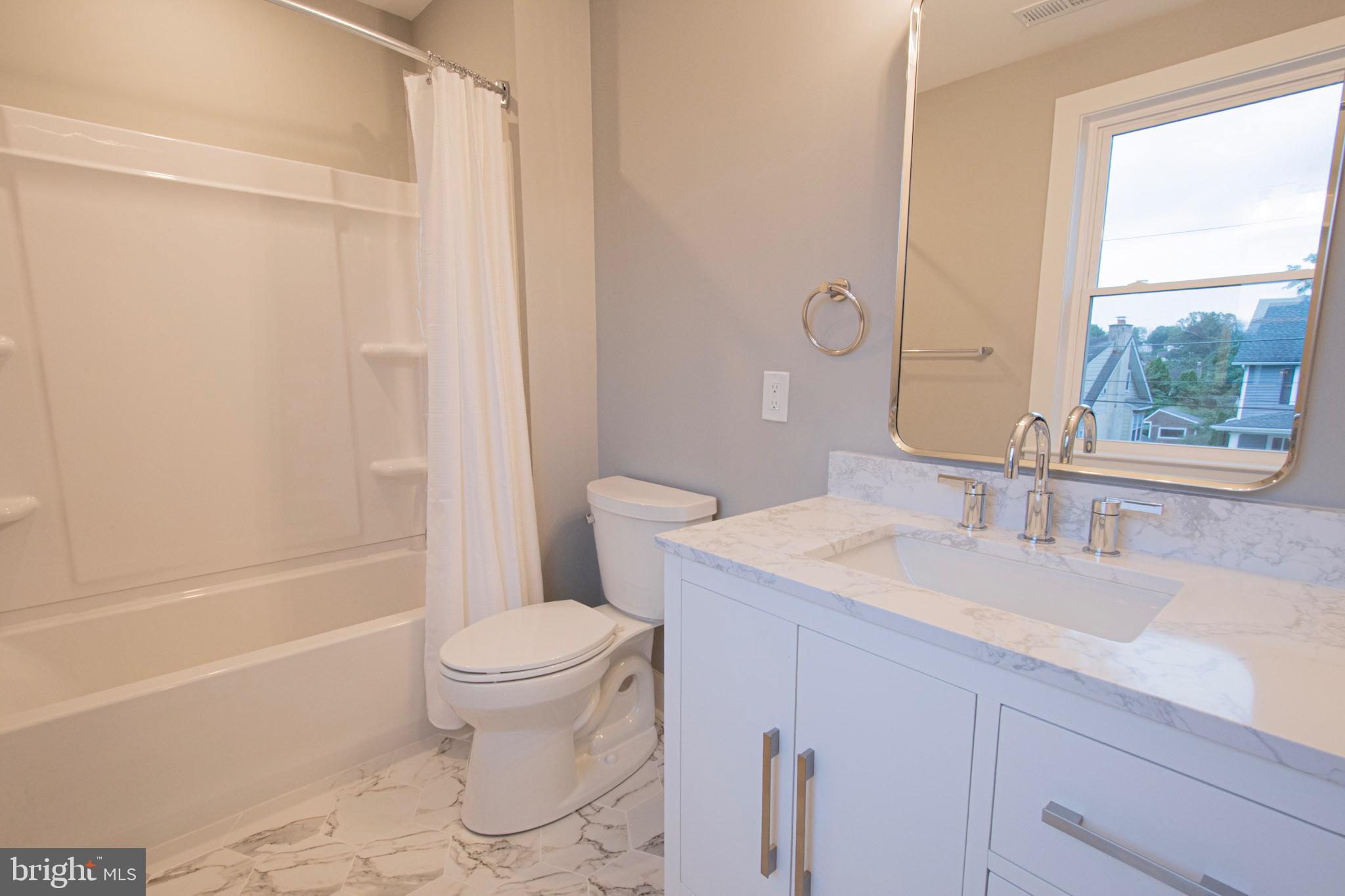 21 Manor Road Paoli, PA 19301 - Photo 17 of 35 a bathroom with a sink a toilet and a bathtub