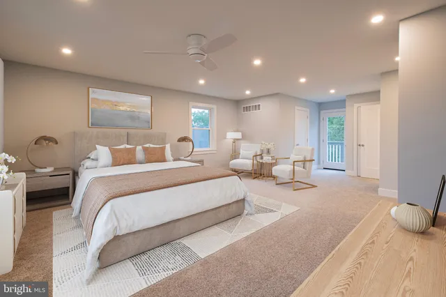 a spacious bedroom with a bed and a large window