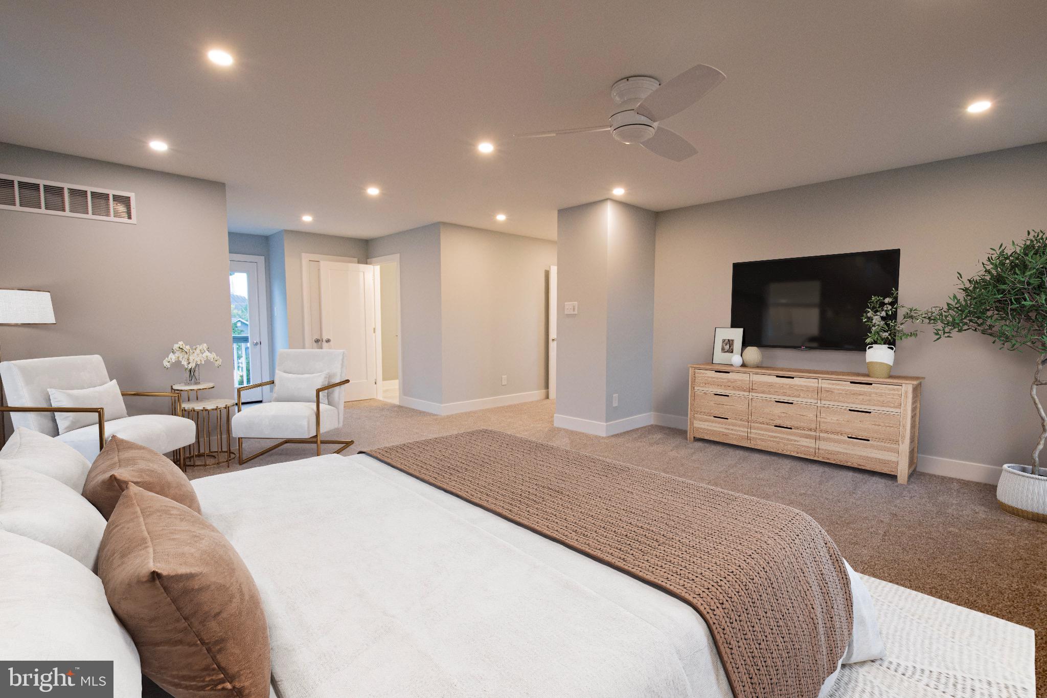 21 Manor Road Paoli, PA 19301 - Photo 21 of 35 a spacious bedroom with a bed a tv and couch