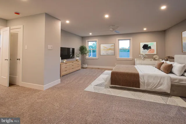 a spacious bedroom with a bed and a television in it