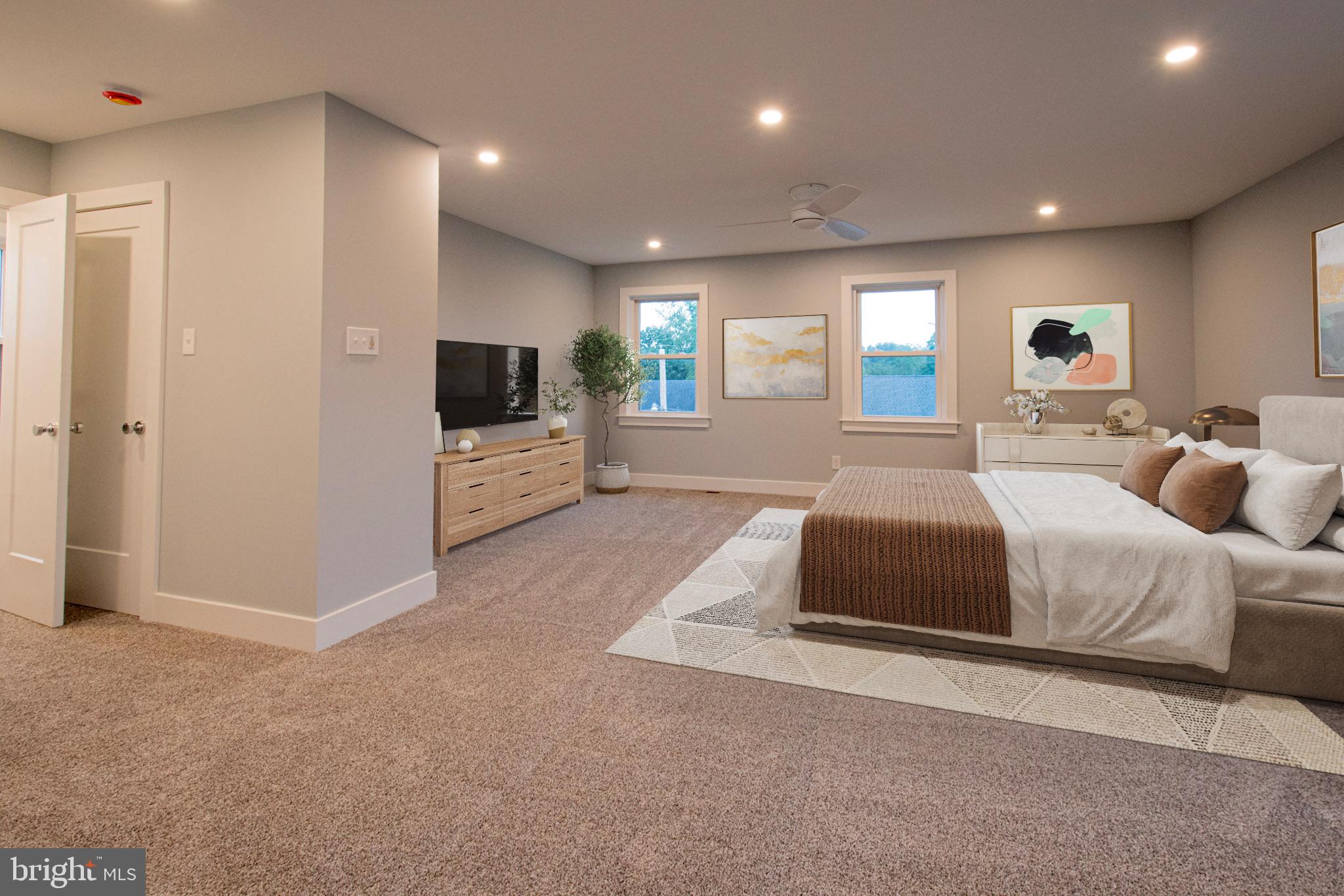 21 Manor Road Paoli, PA 19301 - Photo 22 of 35 a spacious bedroom with a bed and a television in it