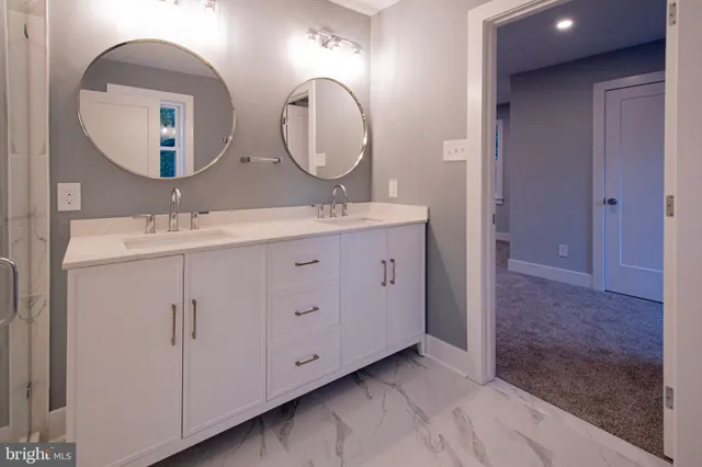 a bathroom with a double vanity sink and a mirror