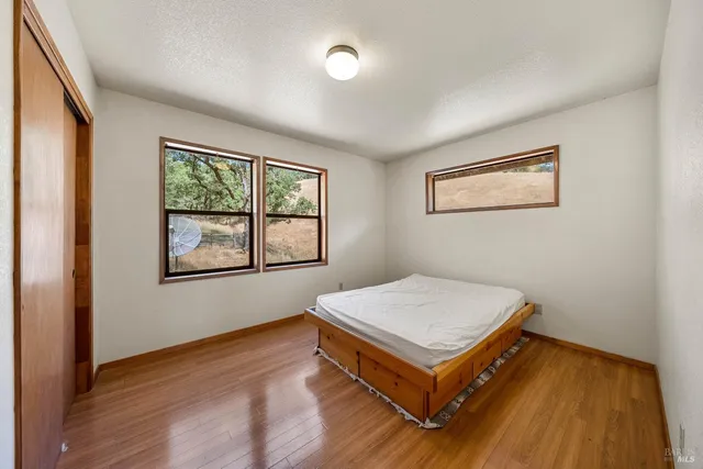 a living room with hard wood floors and a window