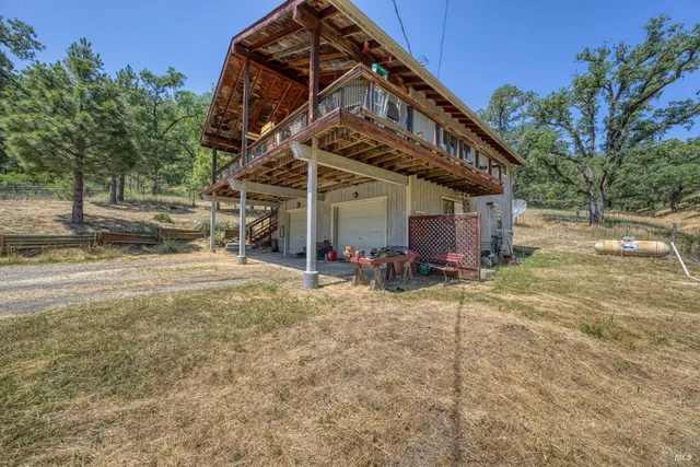 a view of a house with wooden fence