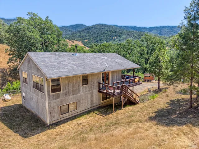 a living room with a bed and a wooden floor