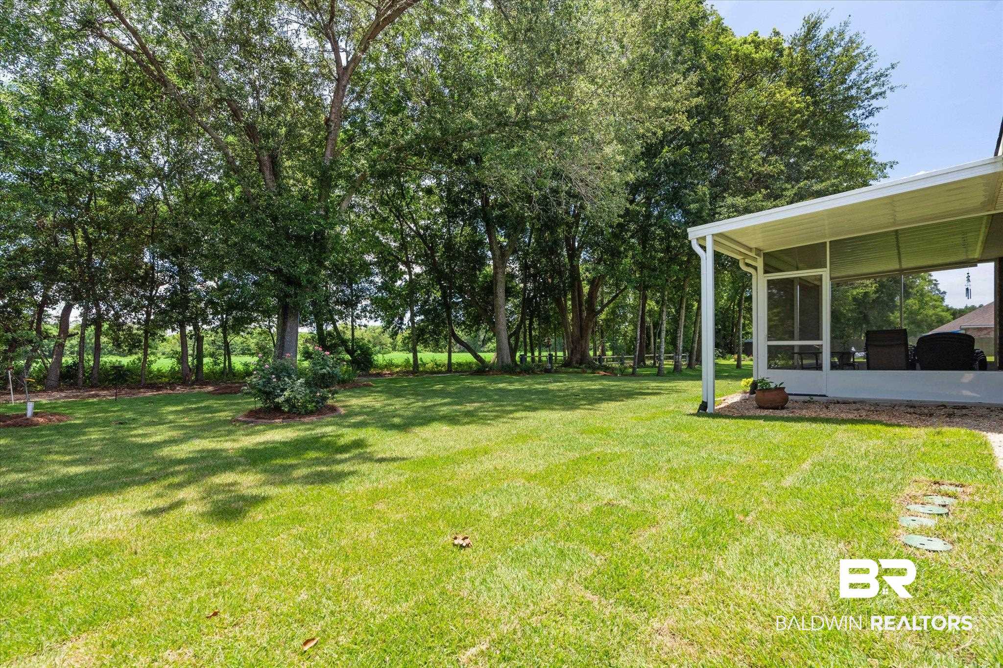 9037 Impala Drive Foley, AL 36535 - Photo 13 of 21 View of grassy yard featuring a sunroom