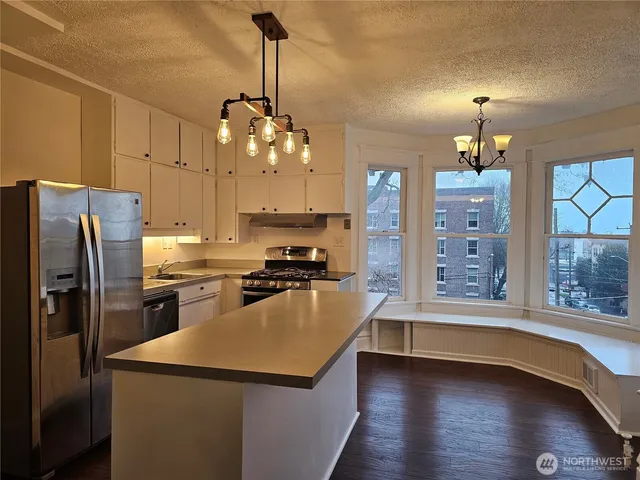 a kitchen with sink refrigerator and stove