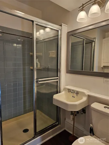a bathroom with a sink mirror toilet and bathtub