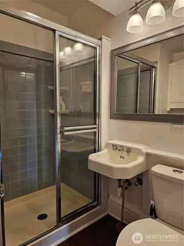 a bathroom with a sink toilet and shower