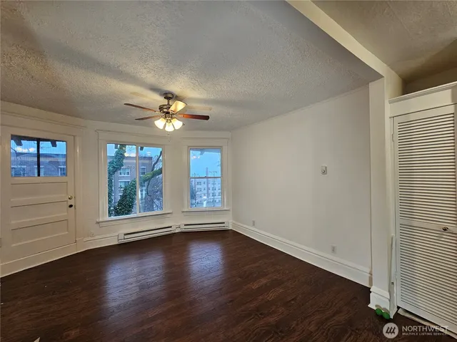 wooden floor in an empty room with a window
