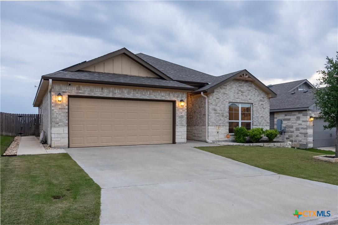 7909 McCulloch Road Temple, TX 76502 - Photo 1 of 46 a front view of a house with a yard and garage