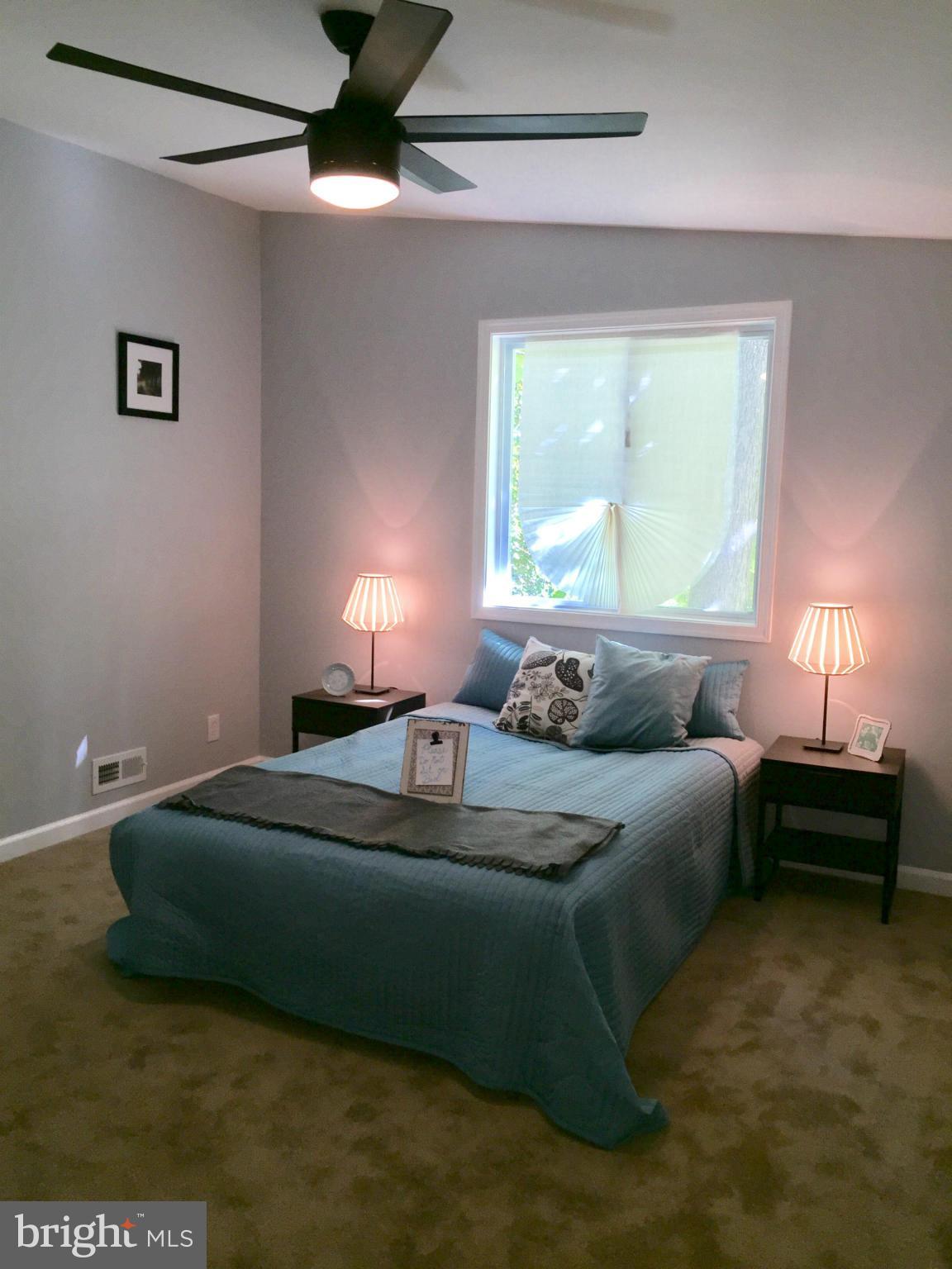 3503 Milford Mill Road Baltimore, MD 21244 - Photo 13 of 27 a bed sitting in a bedroom next to a window
