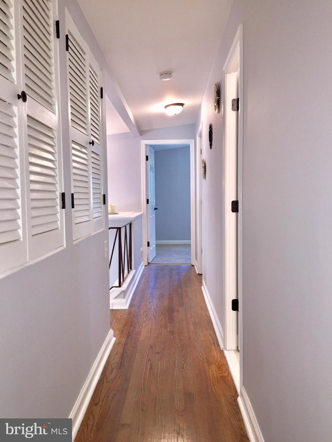 3503 Milford Mill Road Baltimore, MD 21244 - Photo 15 of 27 a view of a hallway with wooden floor and staircase