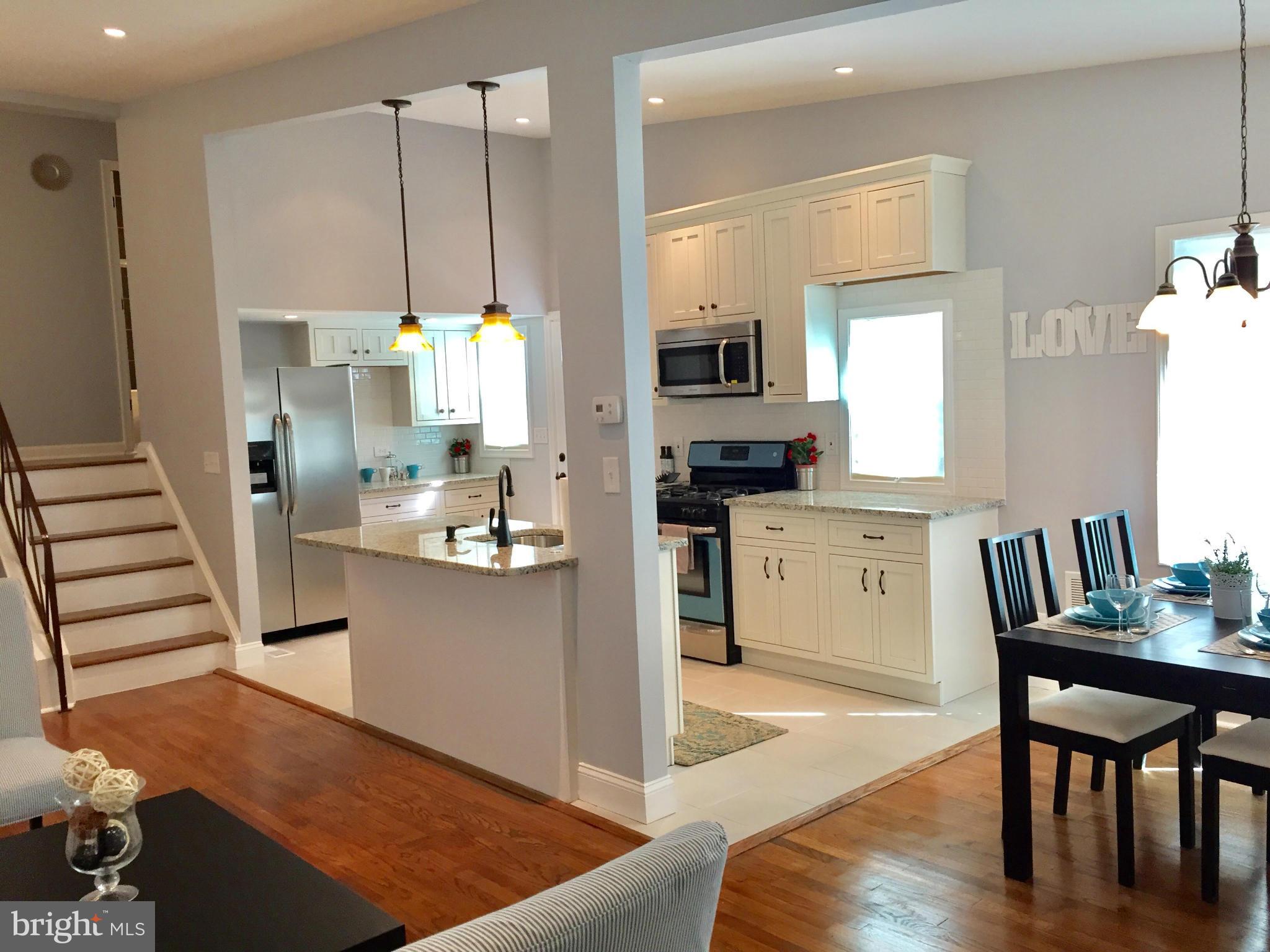 3503 Milford Mill Road Baltimore, MD 21244 - Photo 5 of 27 a kitchen with white cabinets and stainless steel appliances