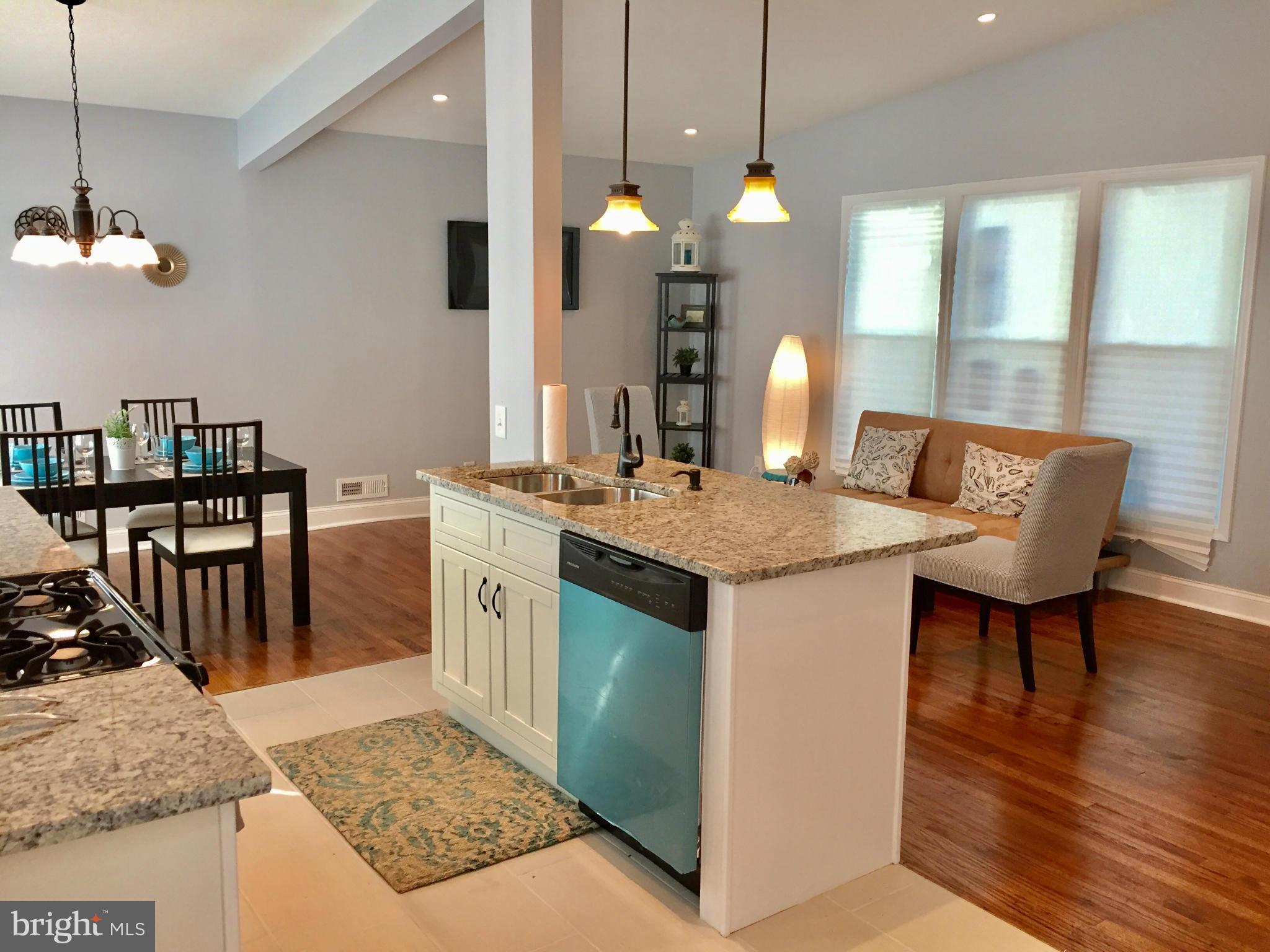 3503 Milford Mill Road Baltimore, MD 21244 - Photo 6 of 27 a kitchen with a table chairs and white cabinets