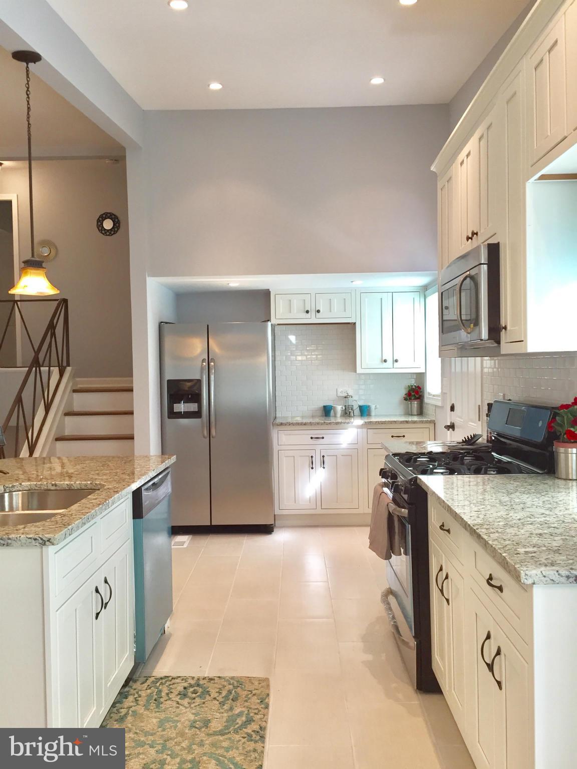 3503 Milford Mill Road Baltimore, MD 21244 - Photo 7 of 27 a large kitchen with stainless steel appliances granite countertop a stove a sink and a refrigerator