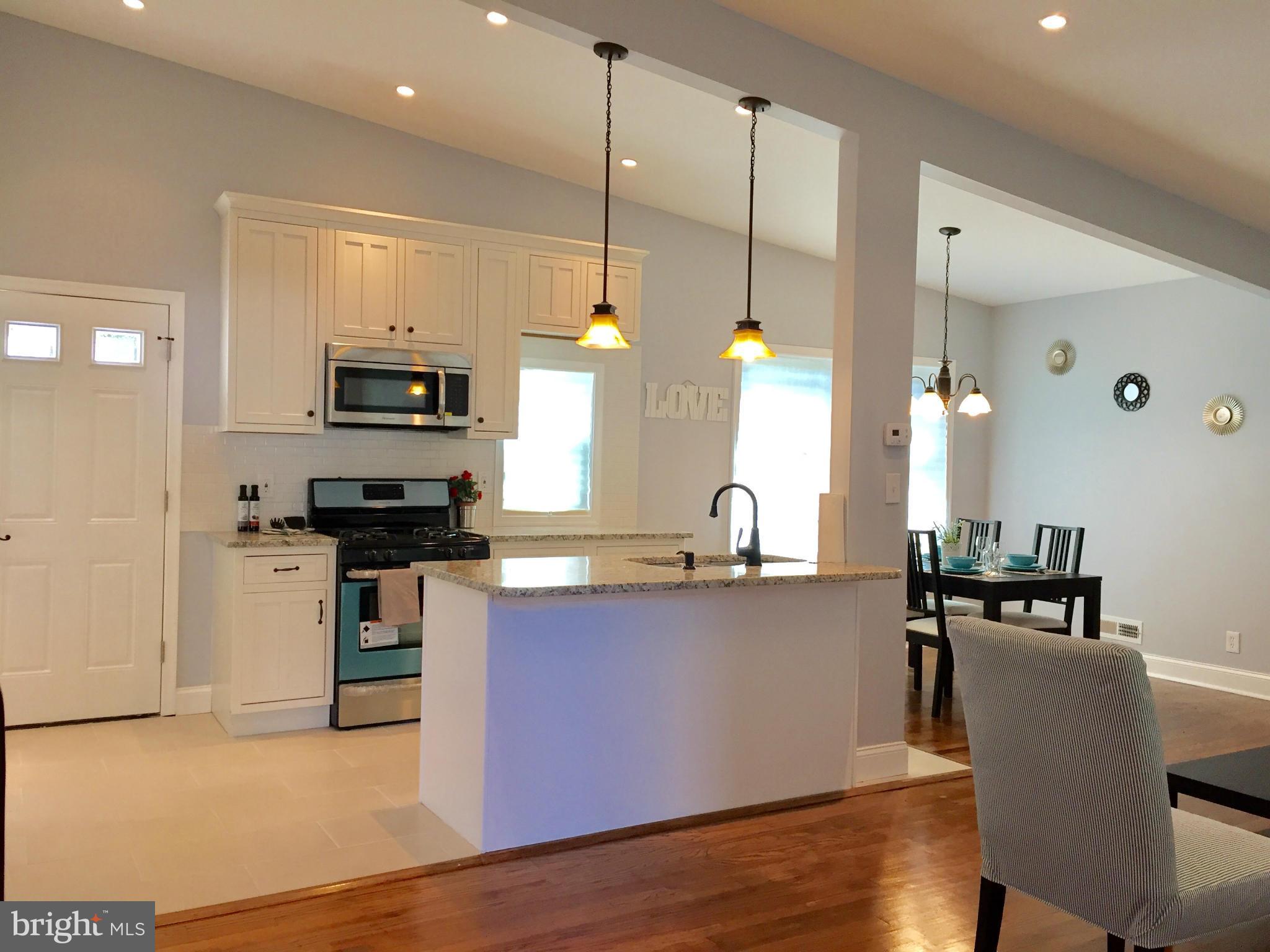 3503 Milford Mill Road Baltimore, MD 21244 - Photo 8 of 27 a kitchen with stainless steel appliances a sink a stove top oven a wooden floors